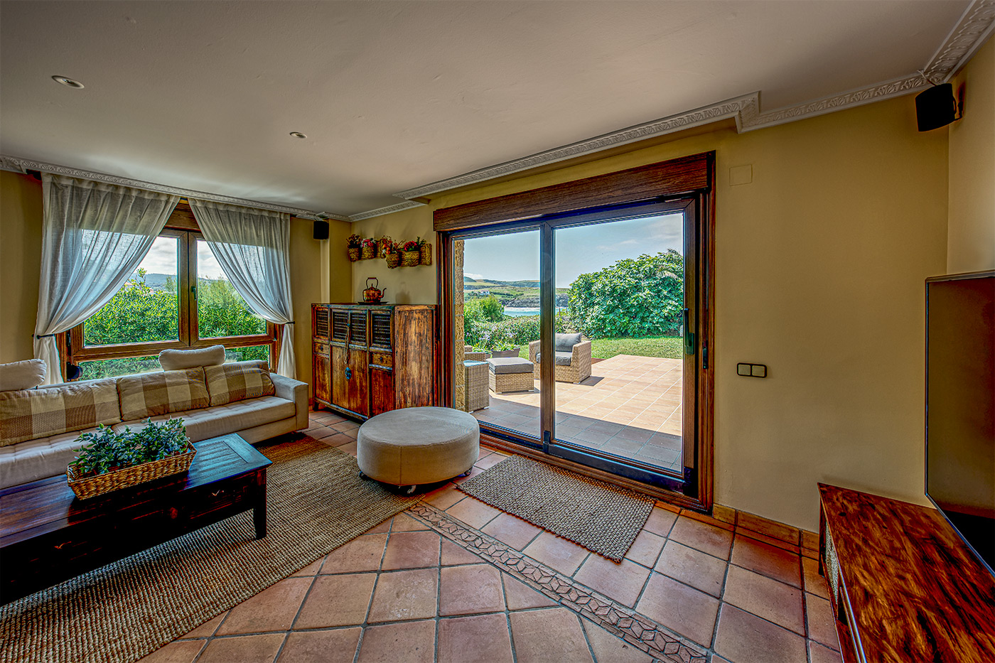 Living area with doors to terrace and sea views